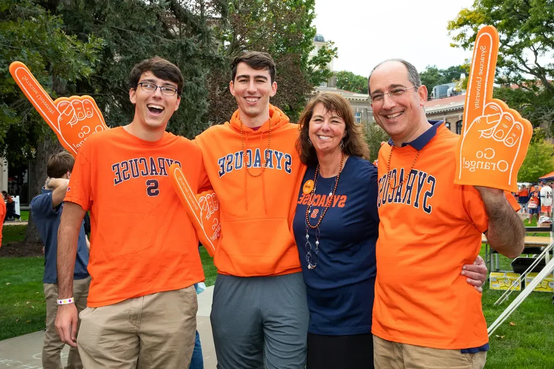 Family posing in Syracuse University shirts.